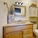 Vanity Nuvo 60-325 Ballerina - 3 Light - 24 in. - Vanity with Alabaster Glass Bell Shades - Old Bronze Finish Nuvo