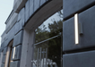 Modern building facade with glass doors and decorative metal elements